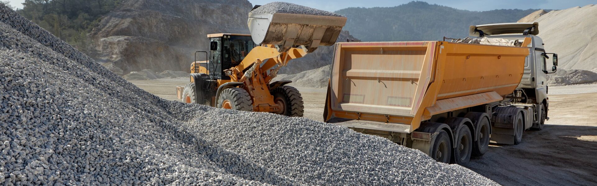 Wheel,Loader,Loads,A,Truck,With,Sand,In,A,Gravel