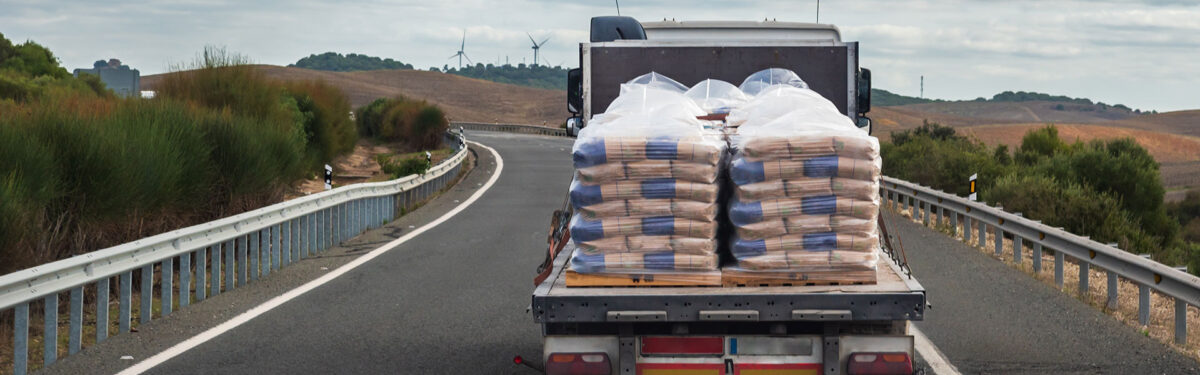Picture of truck with cement bags on the open truckcbed
