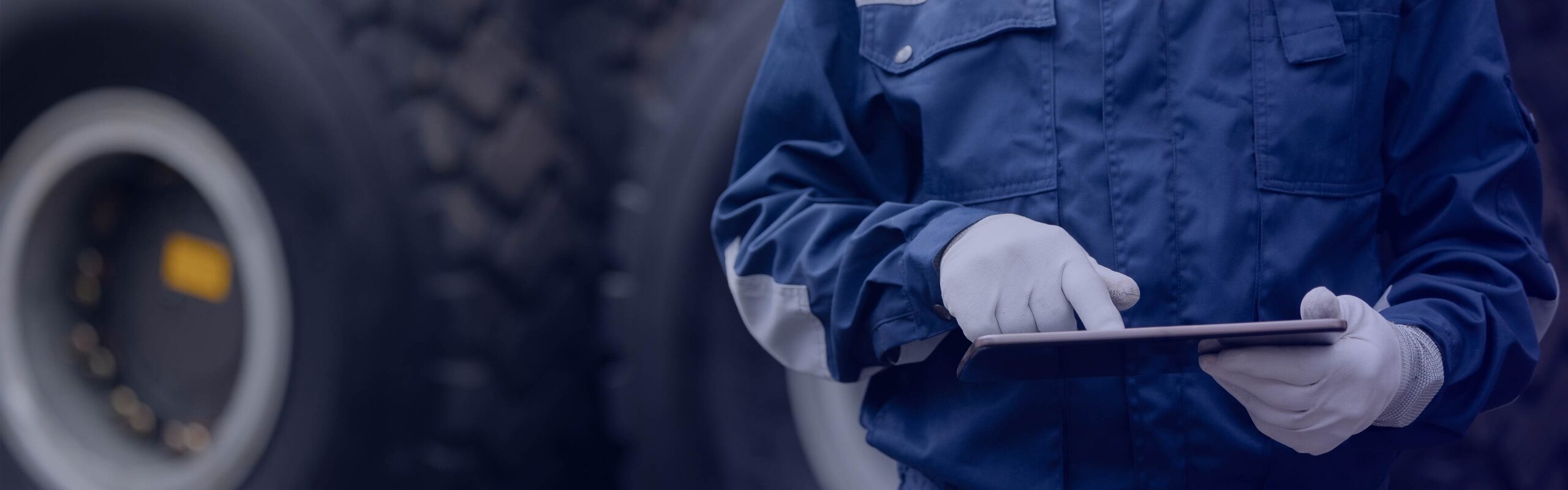 Man in front of truck with tablet